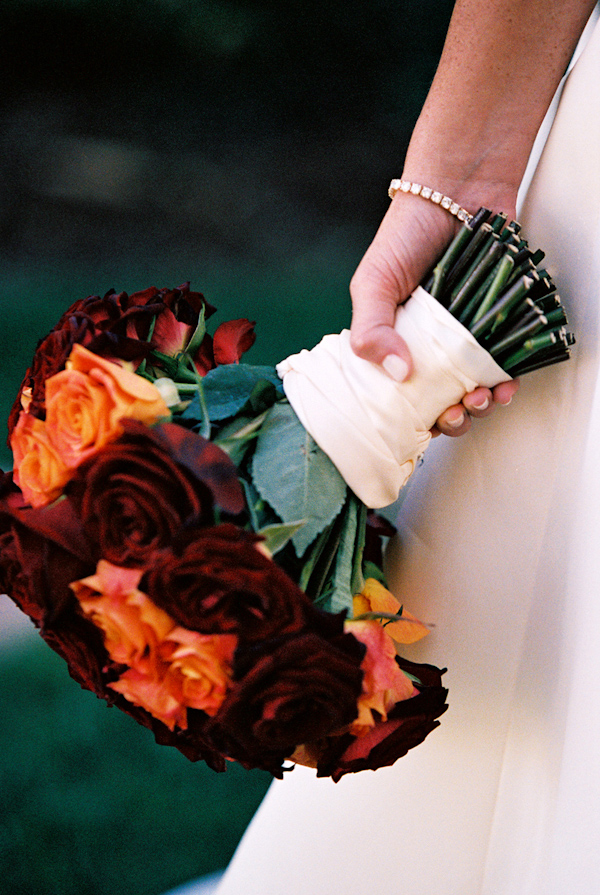 orange and burgundy wedding bouquet photo by Yvette Roman Photography